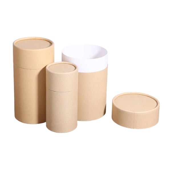 Set of cylindrical cardboard boxes in beige and white on a white background